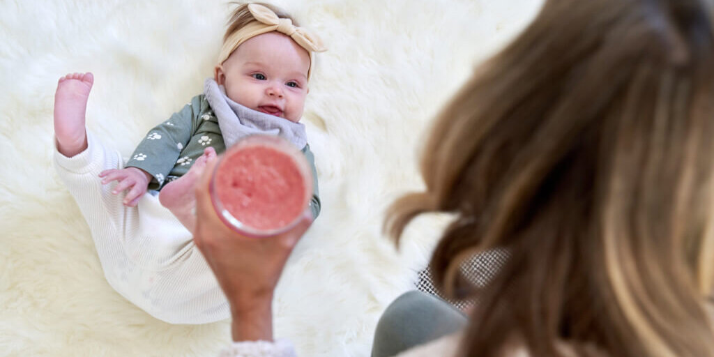 20221011_143_newdrink Image of a happy, healthy baby surrounded by love, showcasing the benefits of Shaklee prenatal support for both moms and babies.