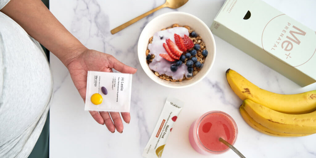 Expectant mother holding a variety of nutritious foods, emphasizing the vital role of nutrition during pregnancy for both mom and baby's health.