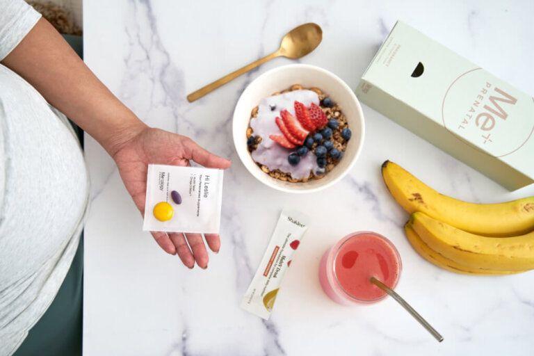 Expectant mother holding a variety of nutritious foods, emphasizing the vital role of nutrition during pregnancy for both mom and baby's health.