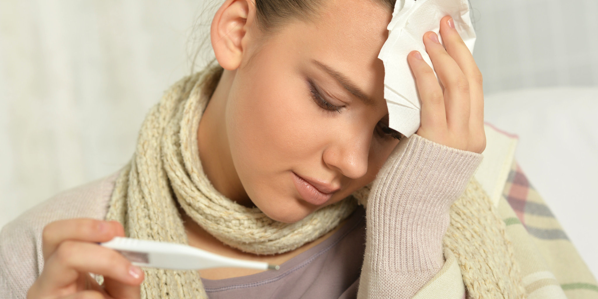 Sick Woman with Thermometer. ThinkstockPhotos Immune