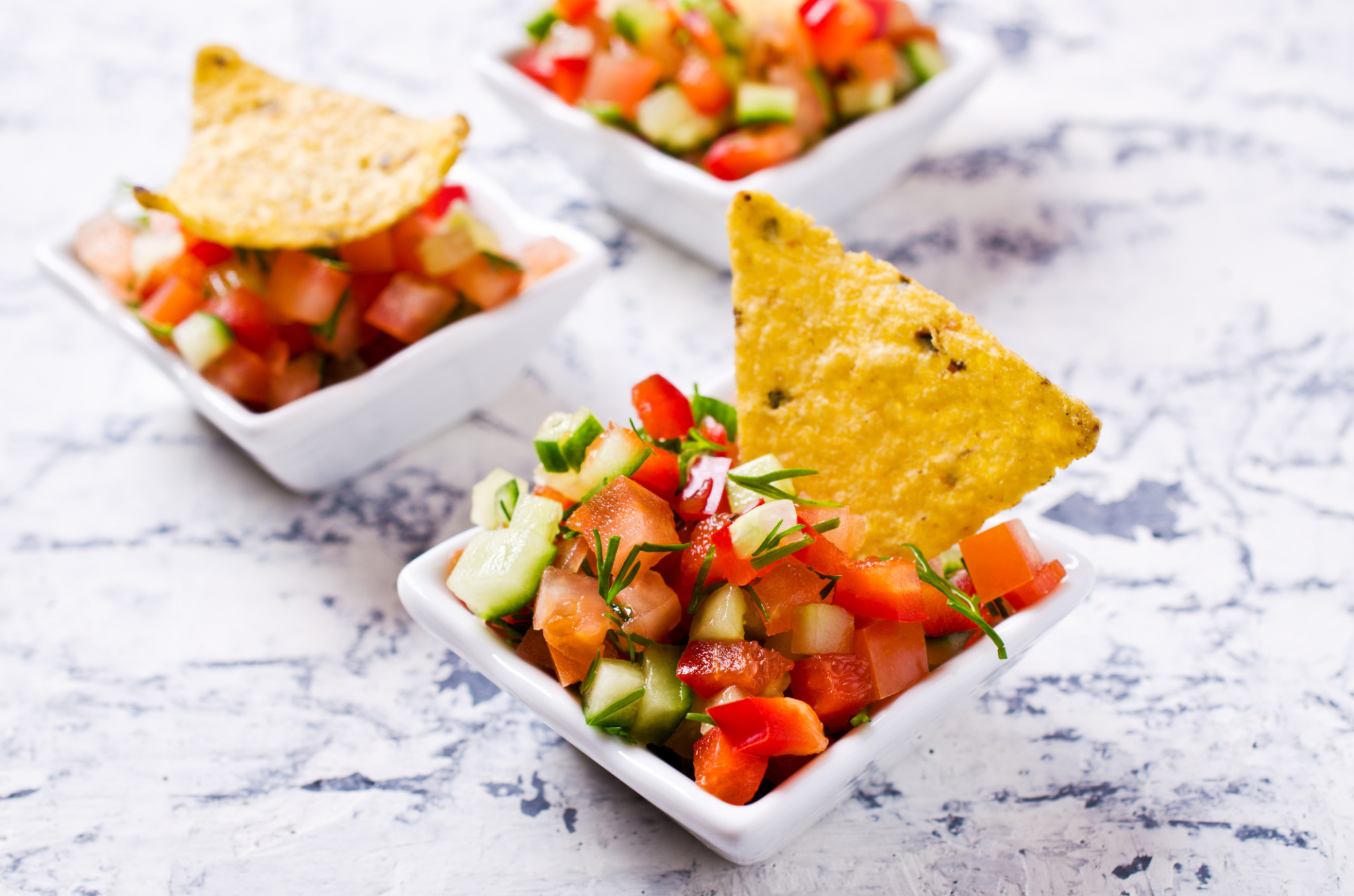 Fresh homemade salsa with vegetables and chips nachos. Selective focus.