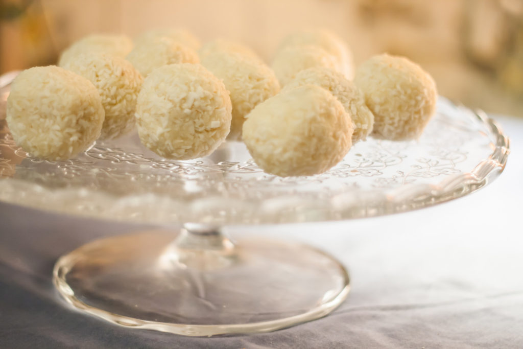 Cakes with coconut truffles in the evening light on a stand.