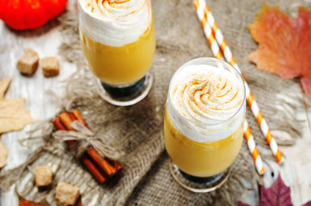 pumpkin spices pie pumpkin milkshake with whipped cream. toning. selective focus