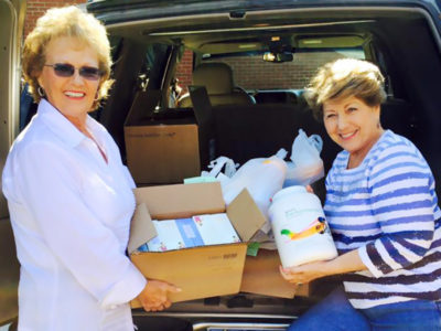 Teri and friend with product in back of car   n