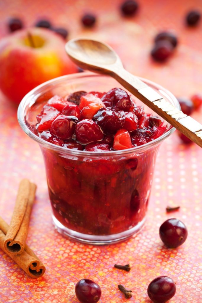 Apple and cranberry chutney with spices in a jar