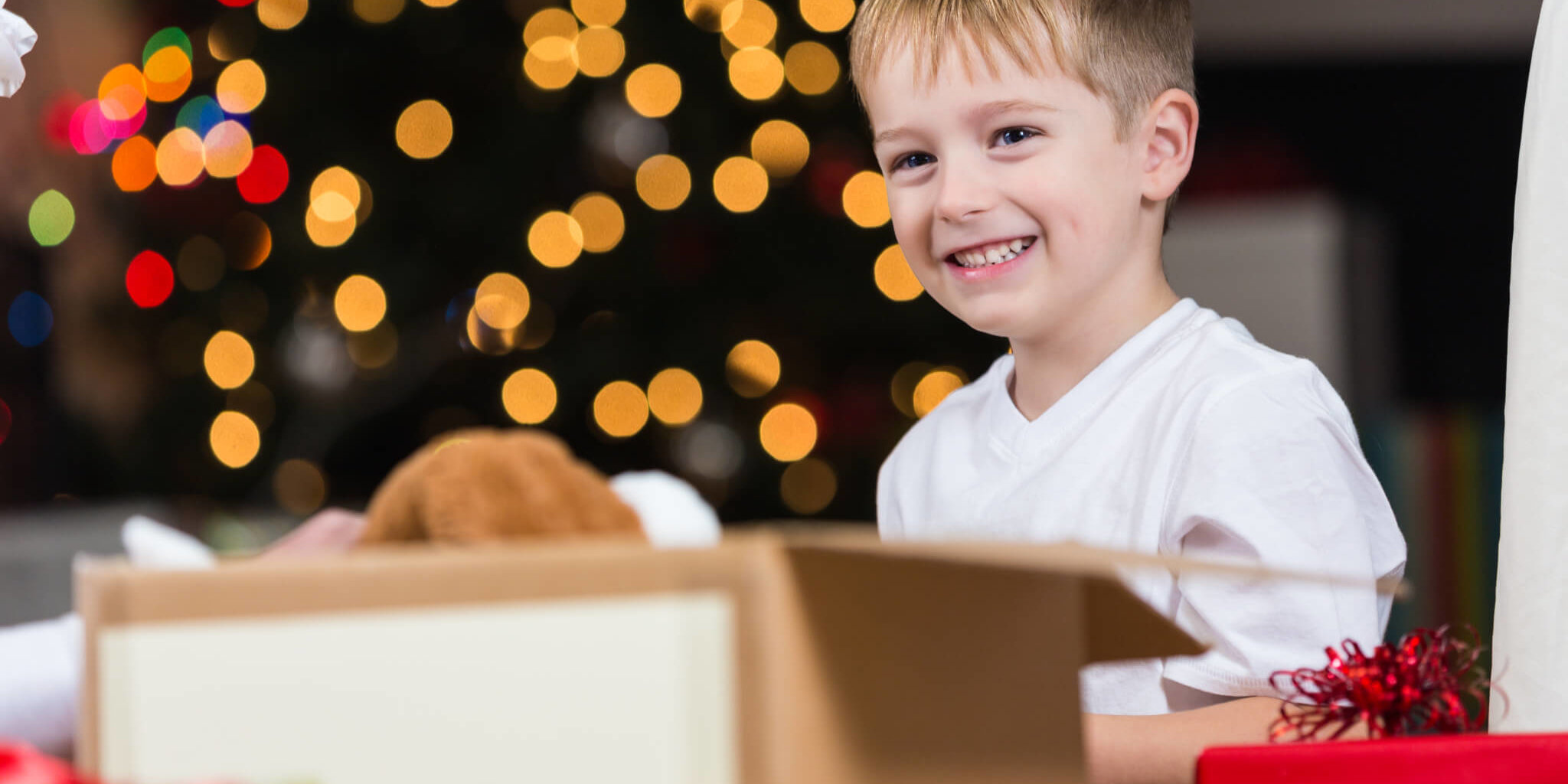Elementary age boy choosing toys to donate for Christmas GettyImages  Small