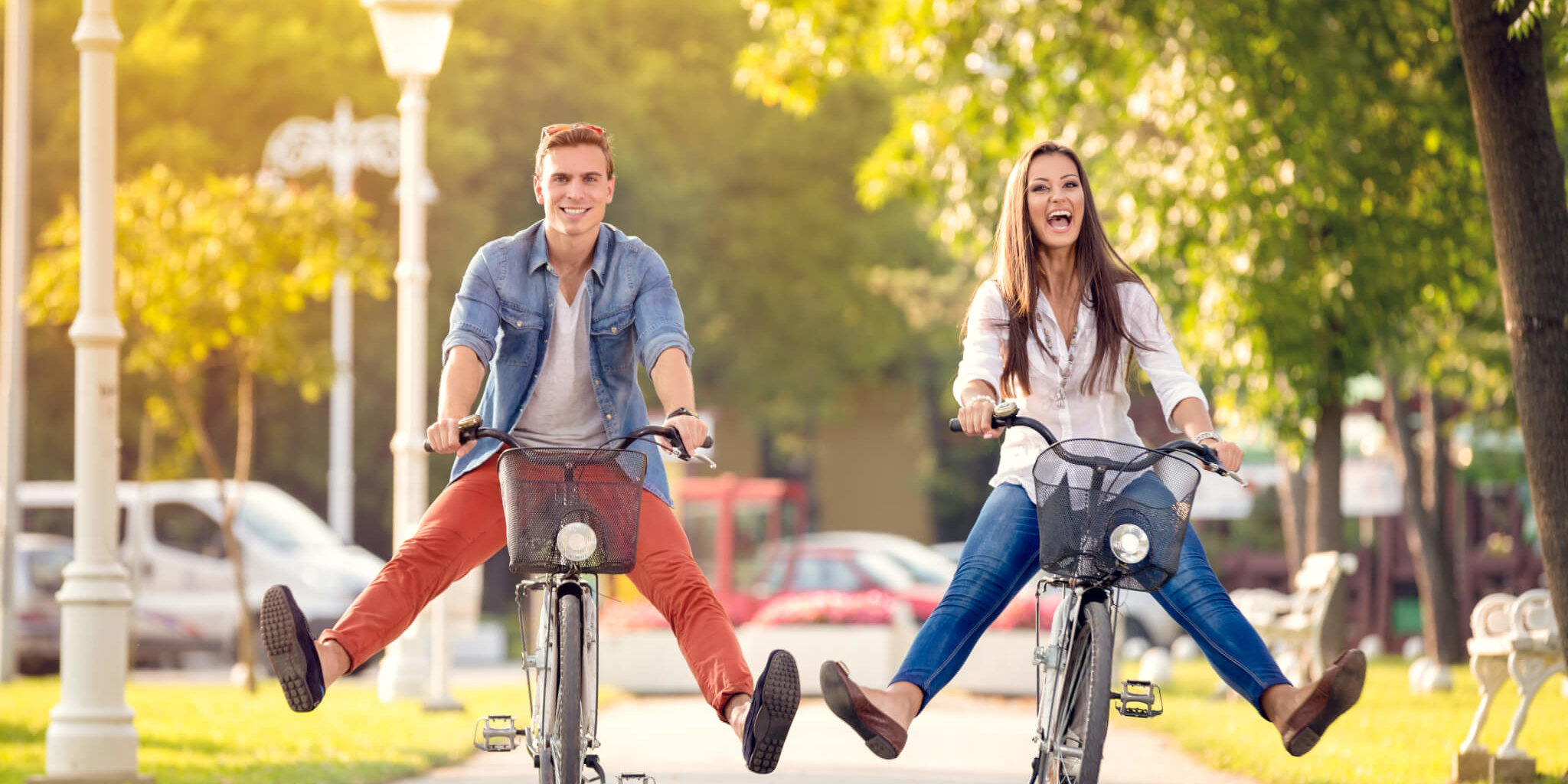 Happy funny couple riding on bicycle AdobeStock