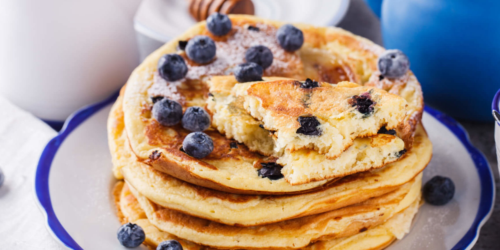 Pancake with banana , blueberries and honey. GettyImages e