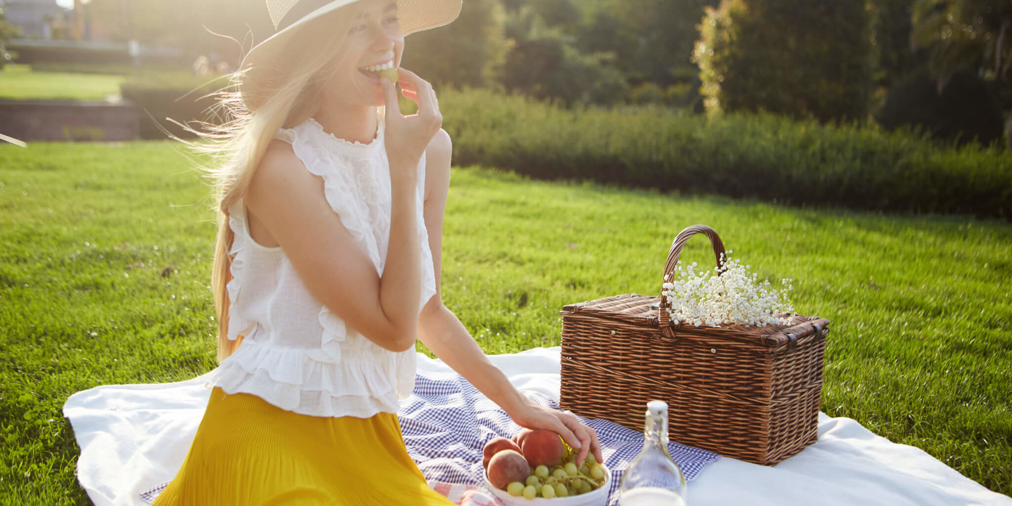 Young woman having picnic in park GettyImages